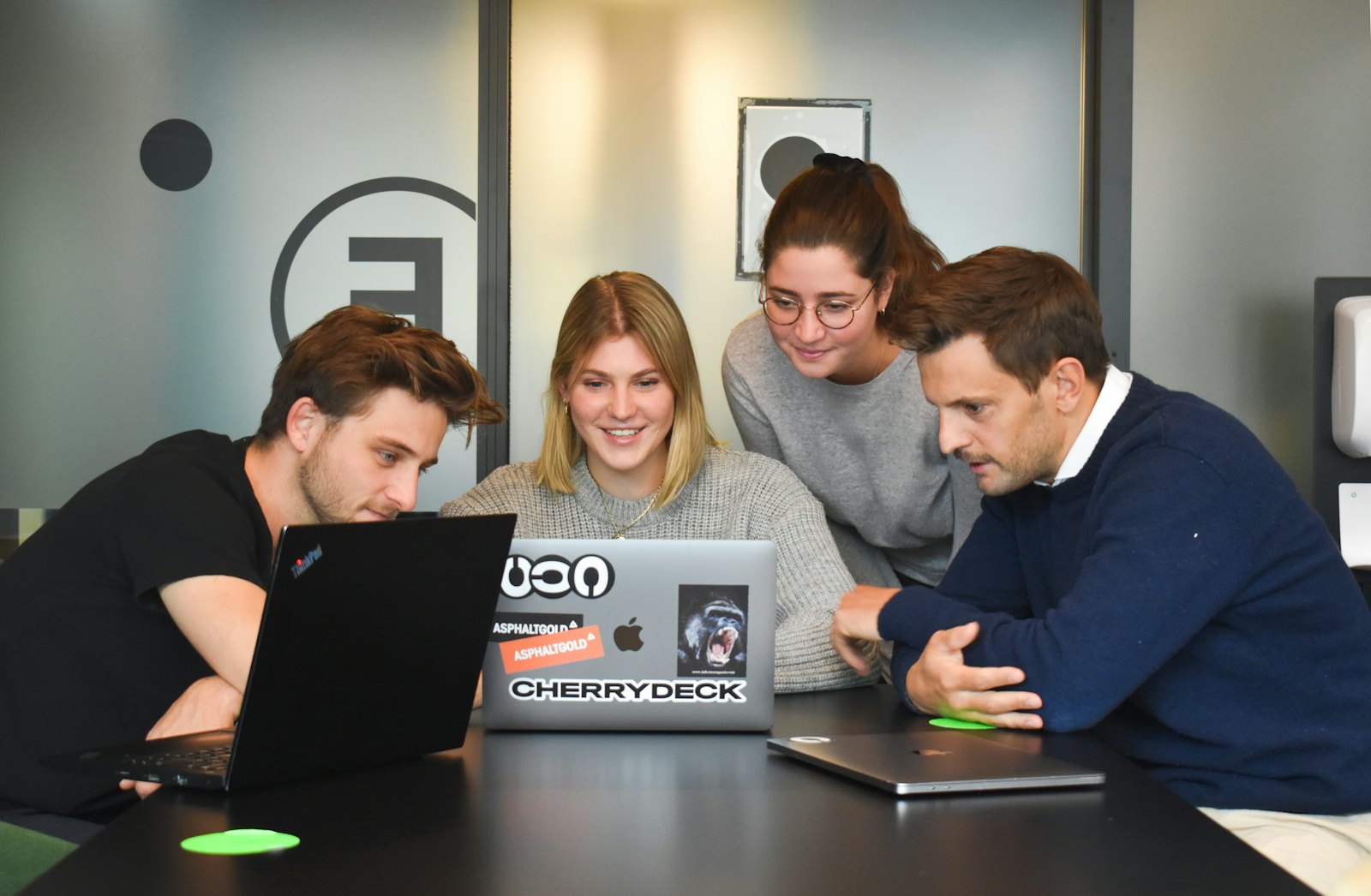 Development team reviewing work together on laptops