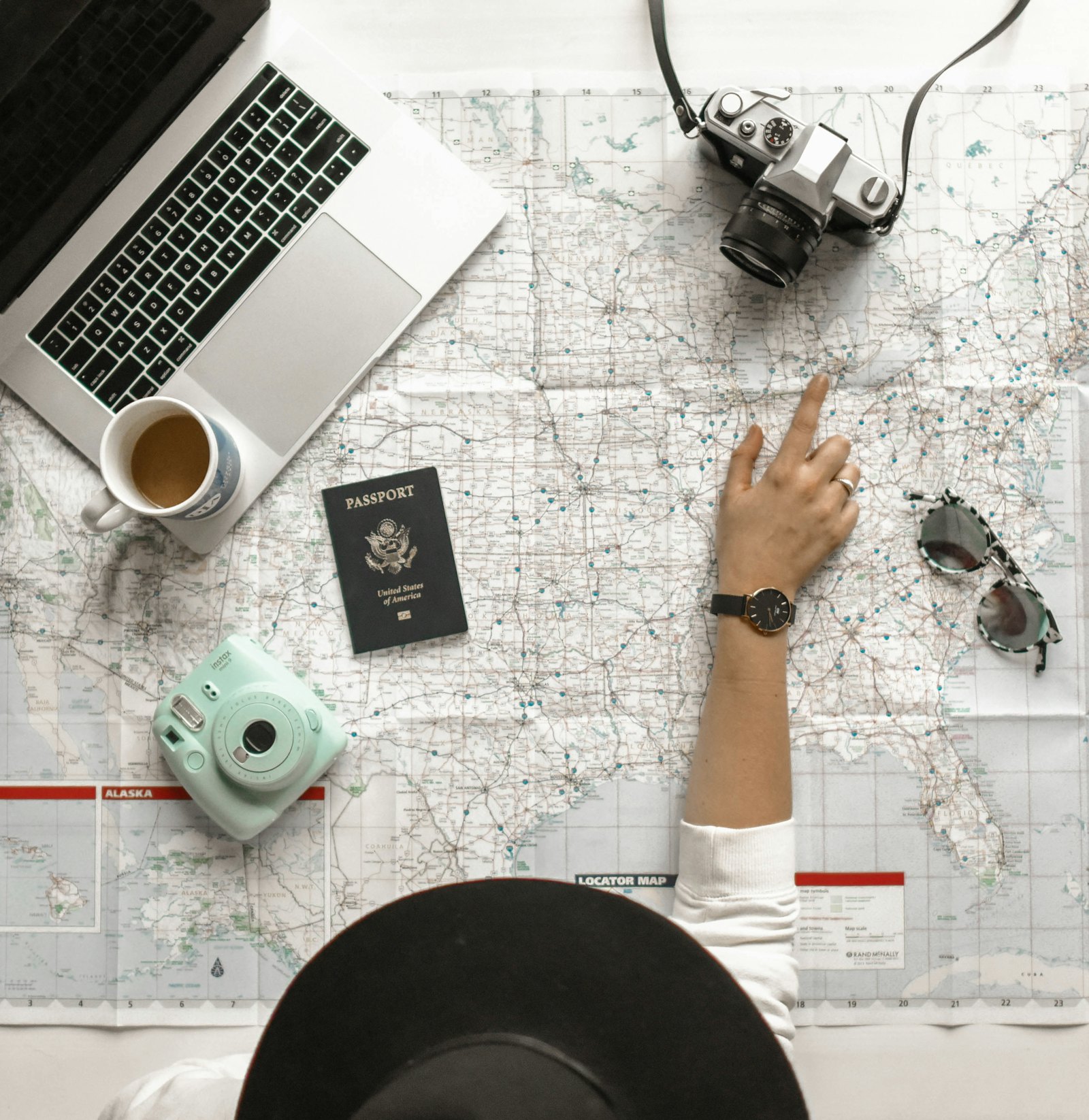 Travel operations desk with laptop, map and passport